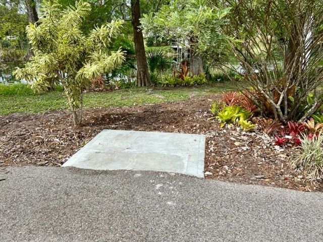 A concrete slab is sitting in the middle of a garden.