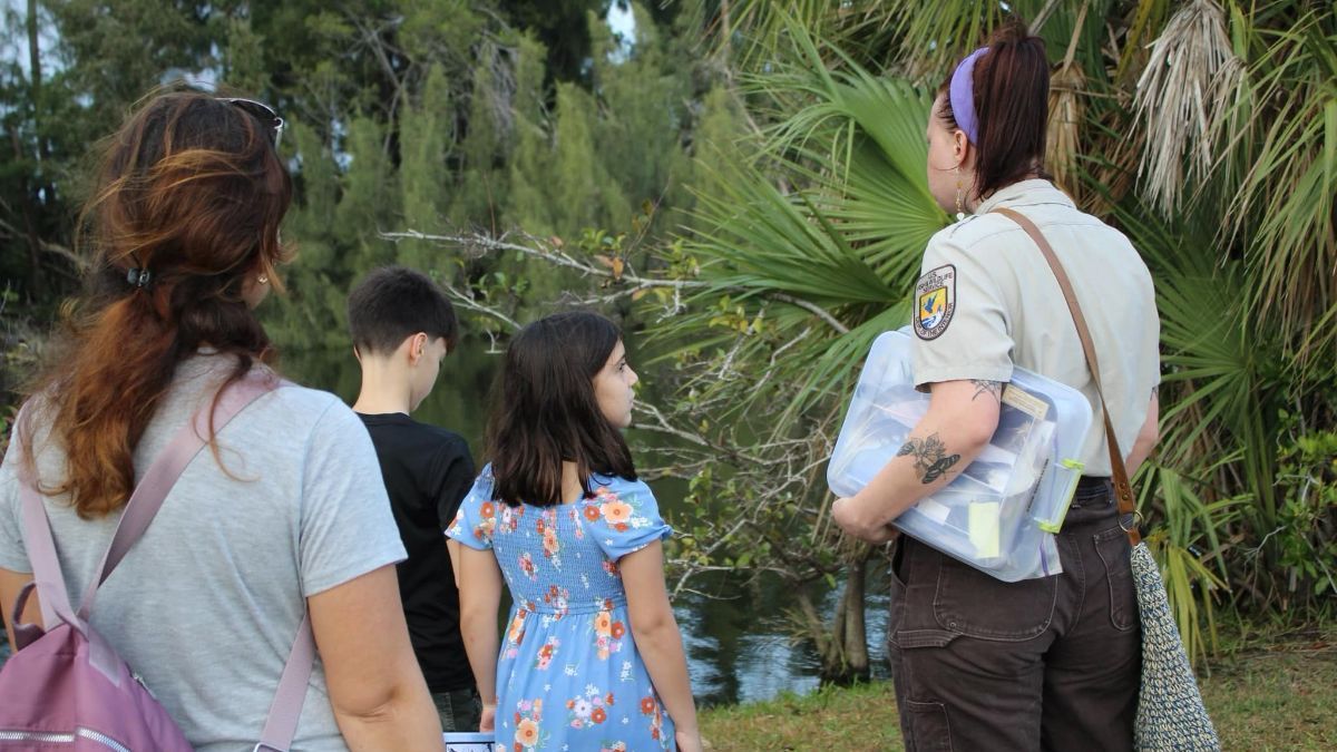 A group of people are standing next to each other in a park.