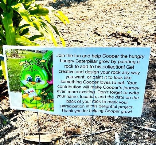 A sign that says `` join the fun and help cooper the hungry caterpillar grow by painting a rock to add to his collection ''