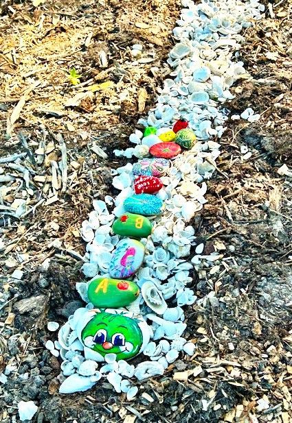 A row of rocks painted to look like a caterpillar.