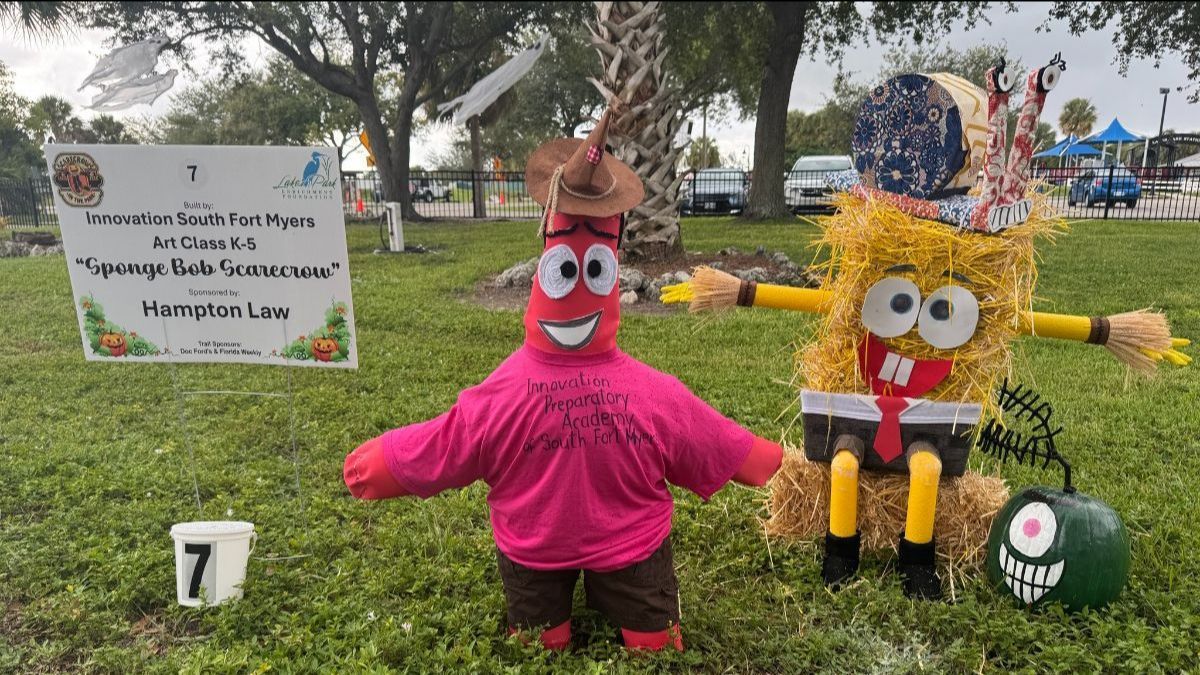 Two cartoon character scarecrows: Patrick and Spongebob, made of straw, in a grassy field.
