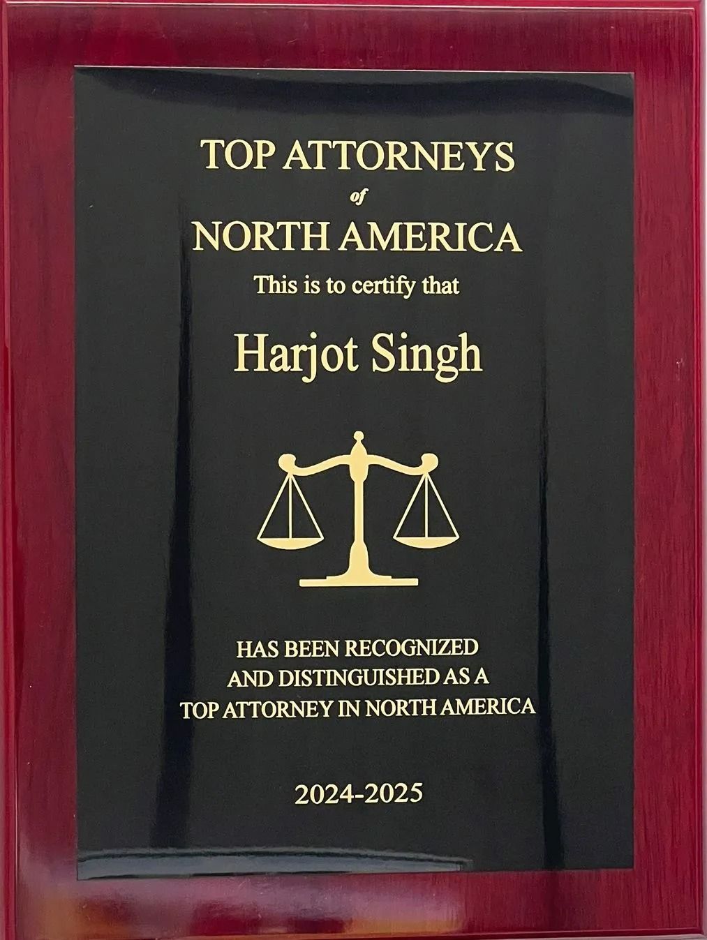 A plaque for Harjot Singh naming them a Top Attorney of North America for 2024-2025, featuring a gold scale of justice icon.