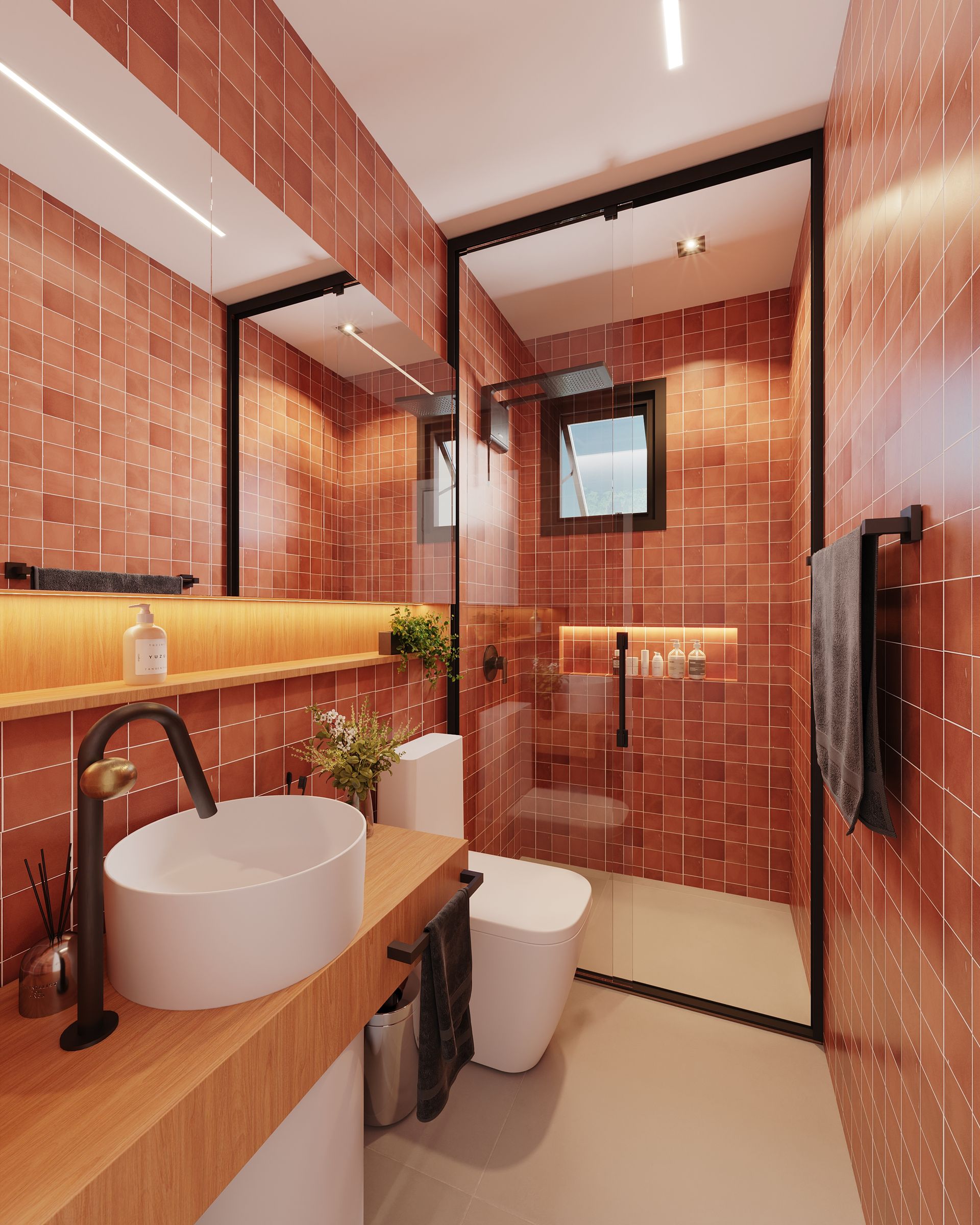 Um banheiro com azulejos vermelhos e uma pia e vaso sanitário