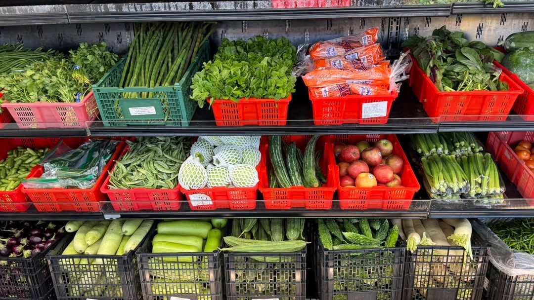 Produce display of fresh fruits and vegetables in colorful crates on store shelves