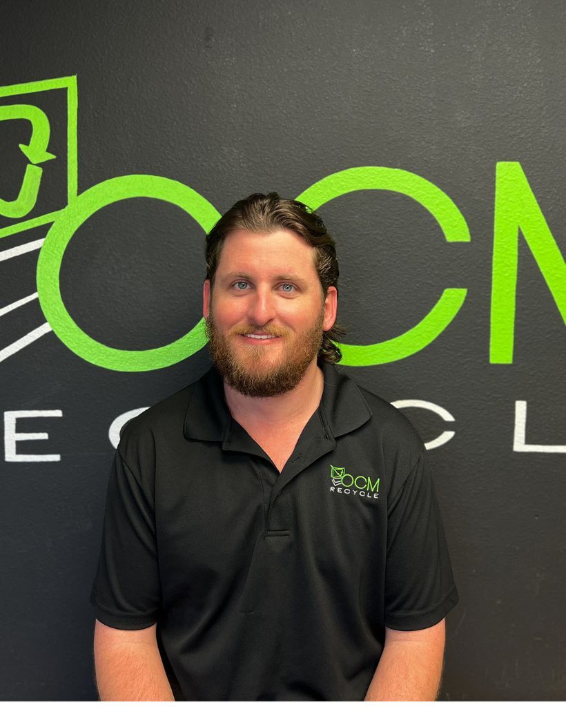 A man with a beard is standing in front of a cn logo
