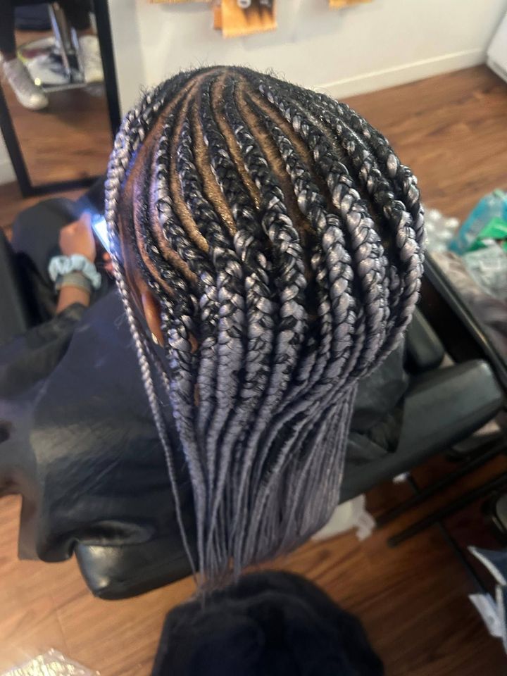Close-up of neatly braided hair styled back in a salon chair.