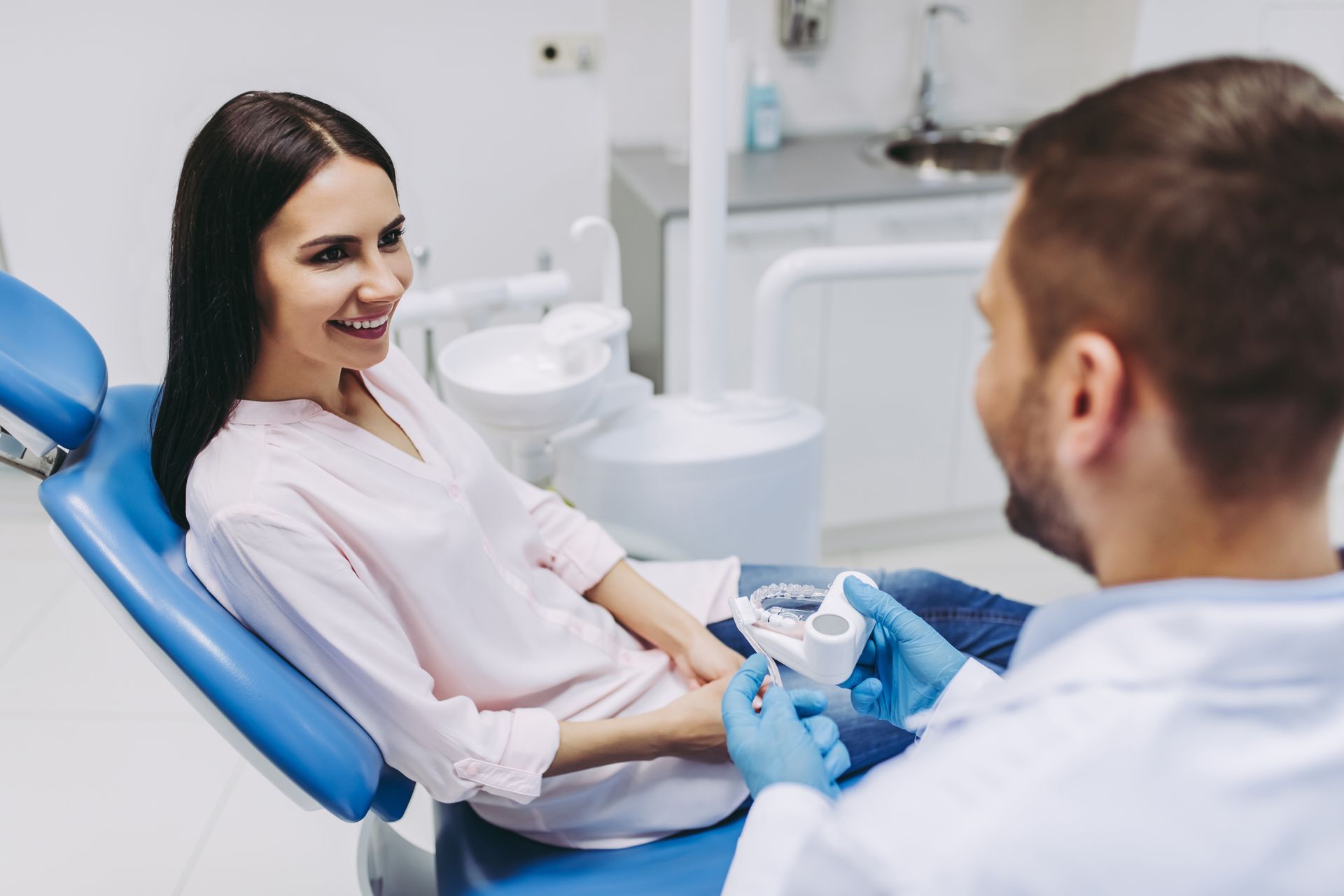 Smiling woman sitting in a dental chair at Martinez & Martinez Family Dental Care dental clinic