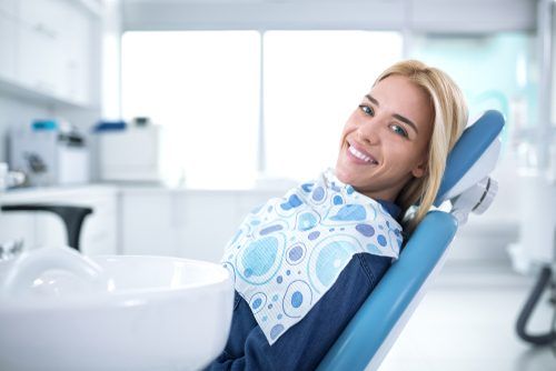 Smiling woman sitting in a dental chair 