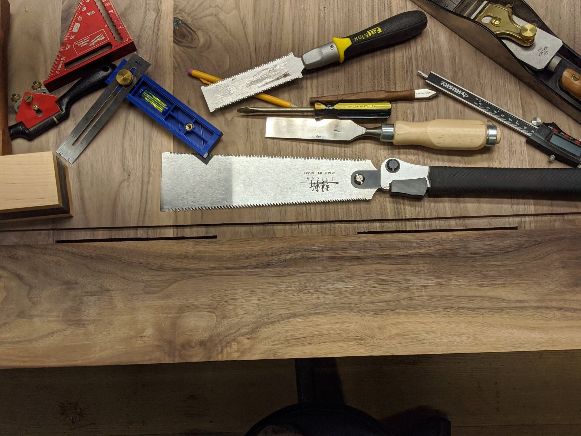 A wooden table with a lot of tools on it