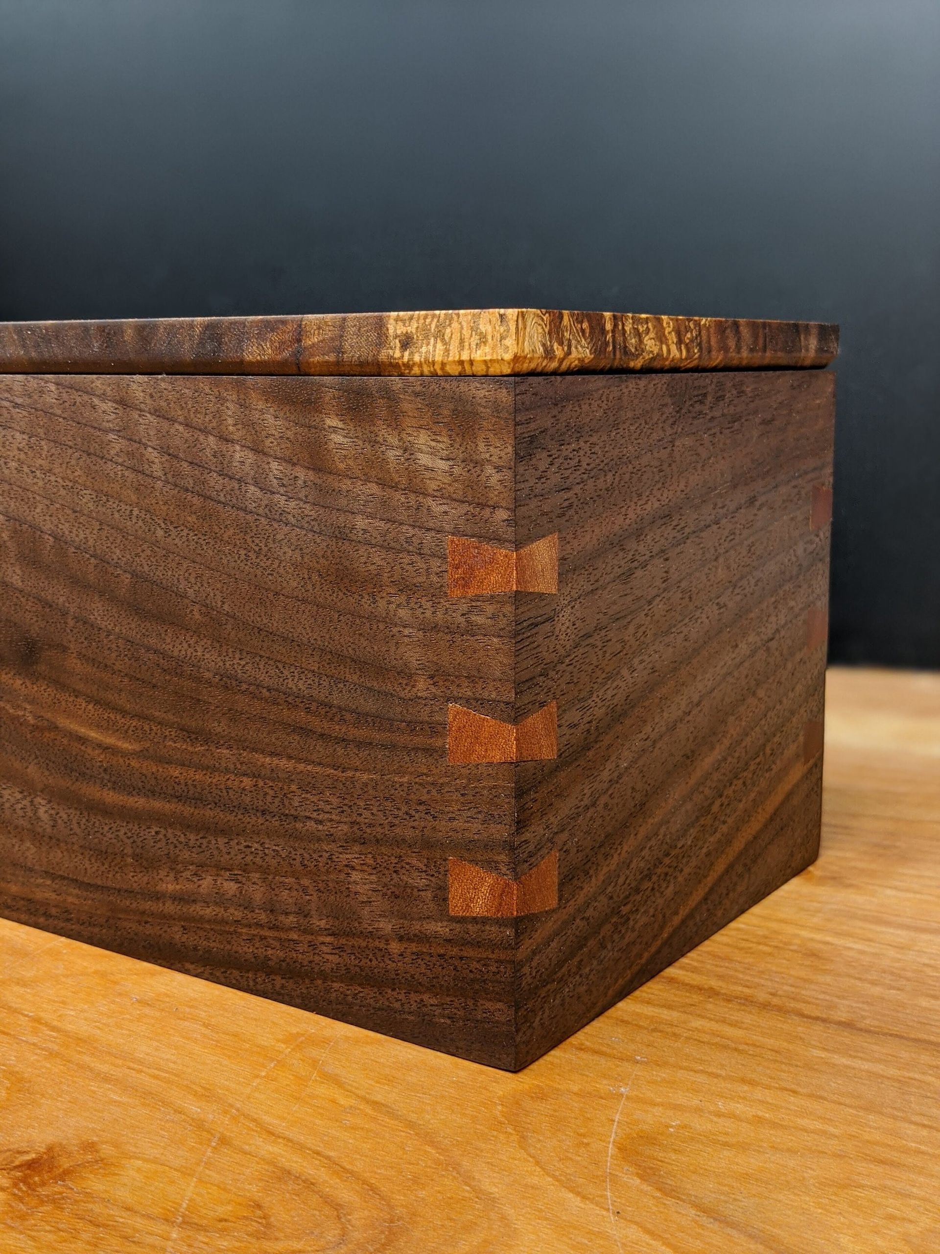 A wooden box is sitting on a wooden table.