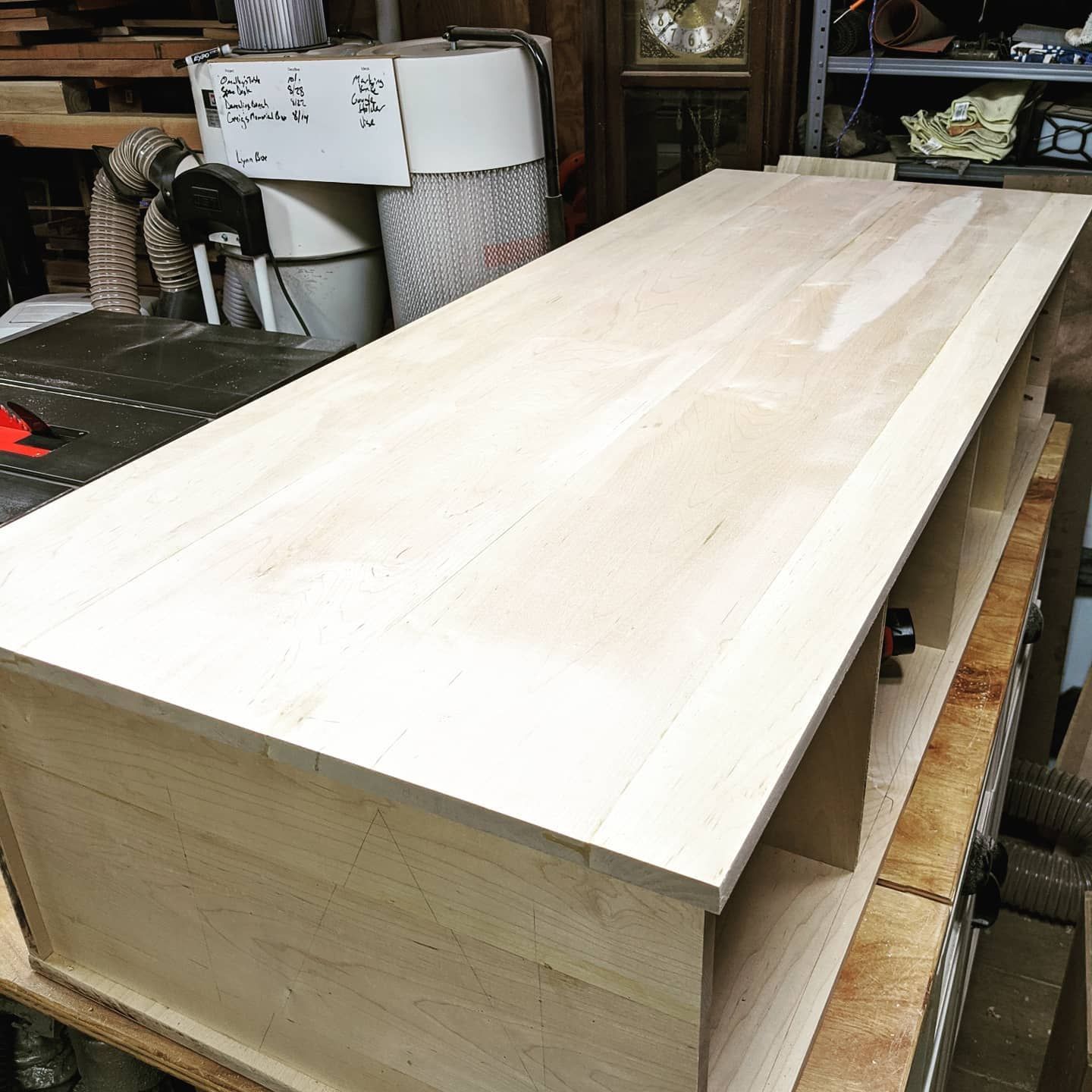A long piece of wood is sitting on top of a table.