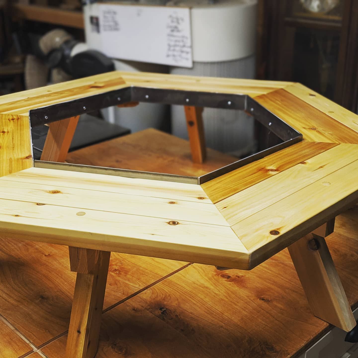 A wooden table has a hole in the middle of it