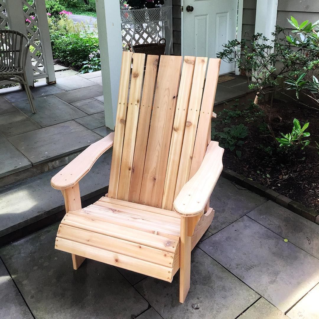 A wooden chair is sitting on a patio next to a door