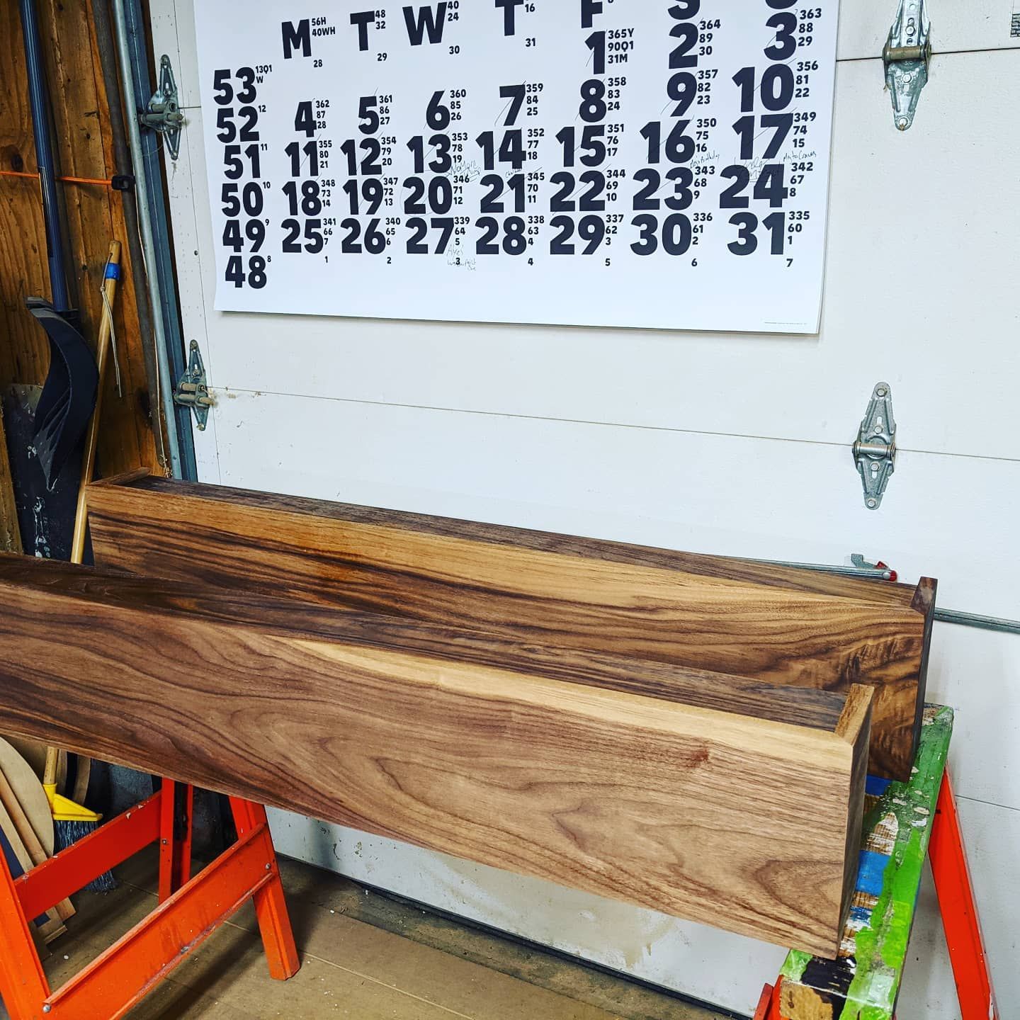 A wooden beam is sitting in front of a calendar that says mtwt