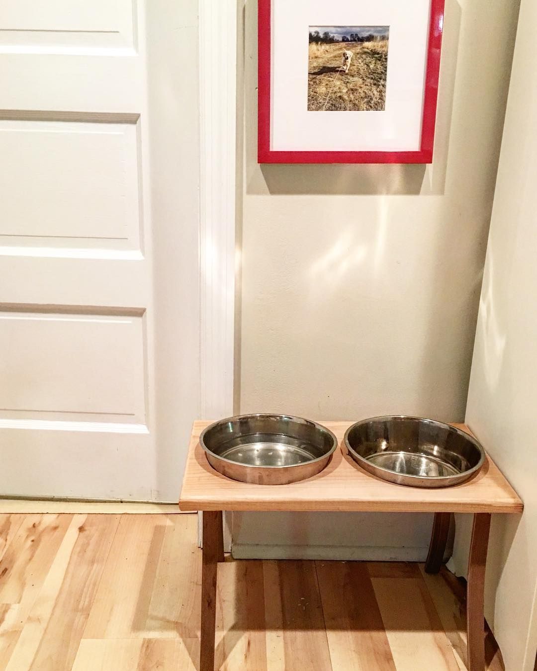 Two stainless steel bowls are sitting on a wooden table.