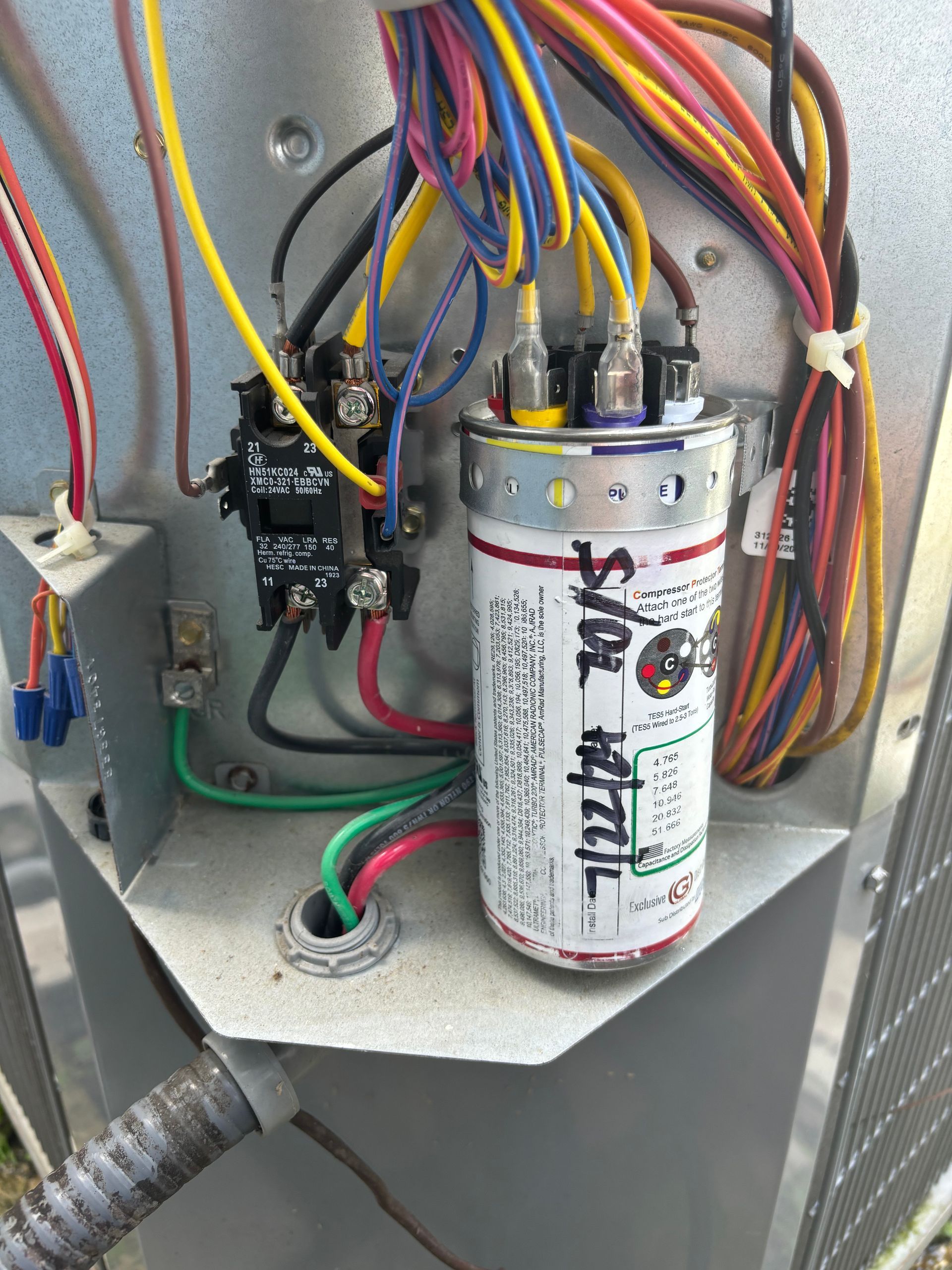 A electrical box with a capacitor that says 400 watts on it