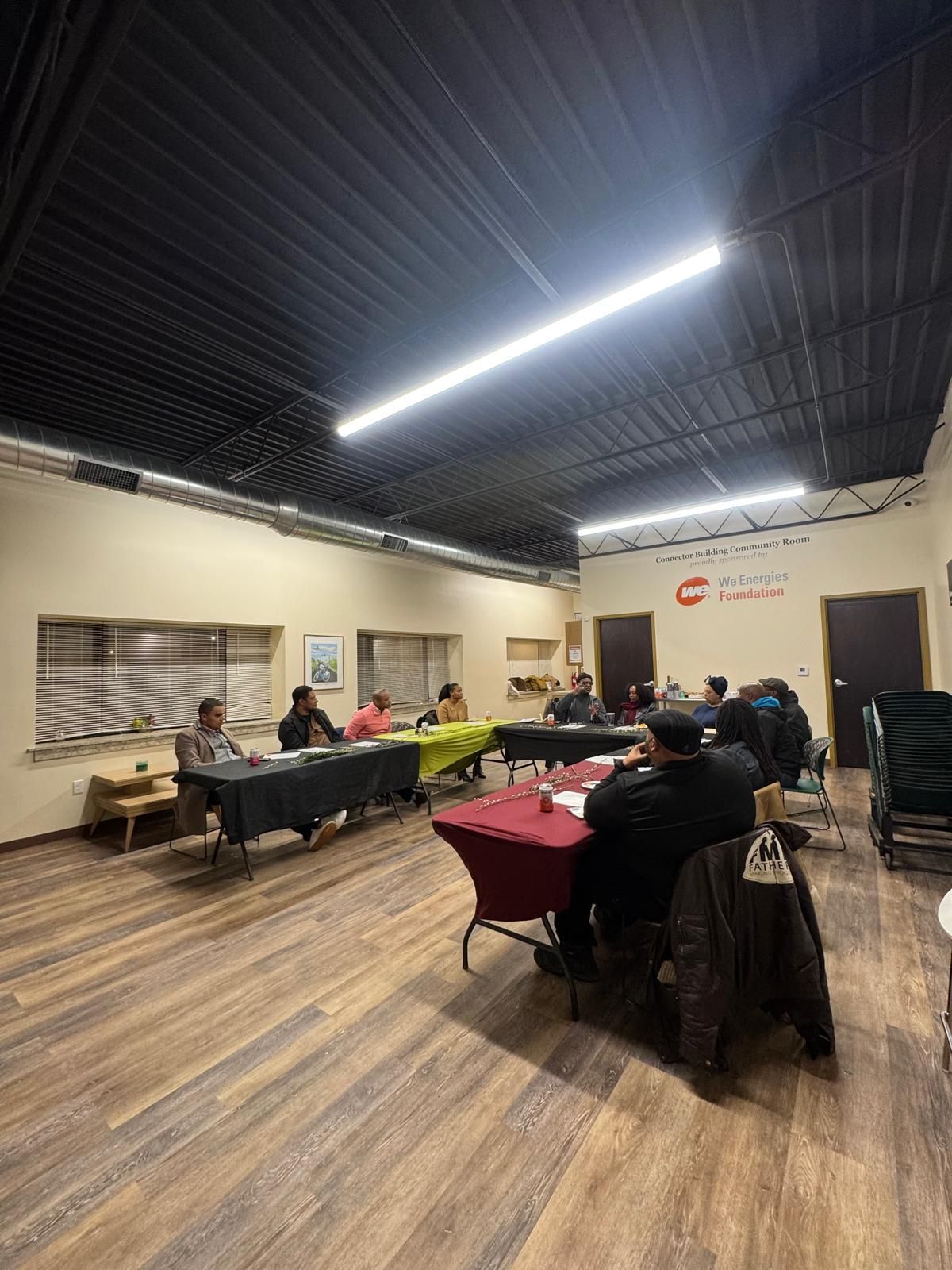 Stakeholders convening at a community space to discuss housing development in Milwaukee.
