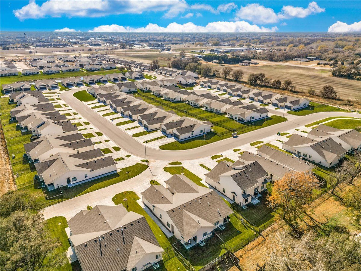 An aerial view of a residential neighborhood with lots of houses and trees.