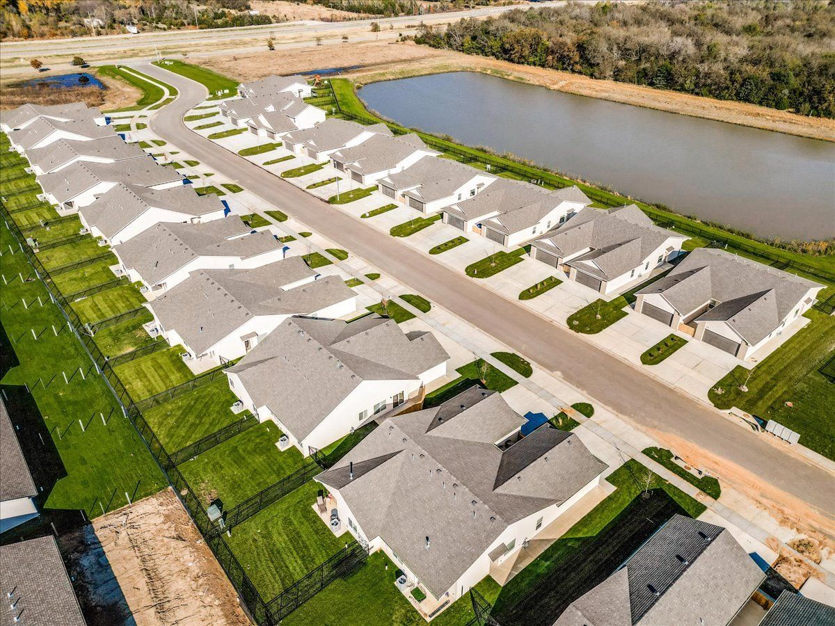 An aerial view of a residential neighborhood with a lake in the background.