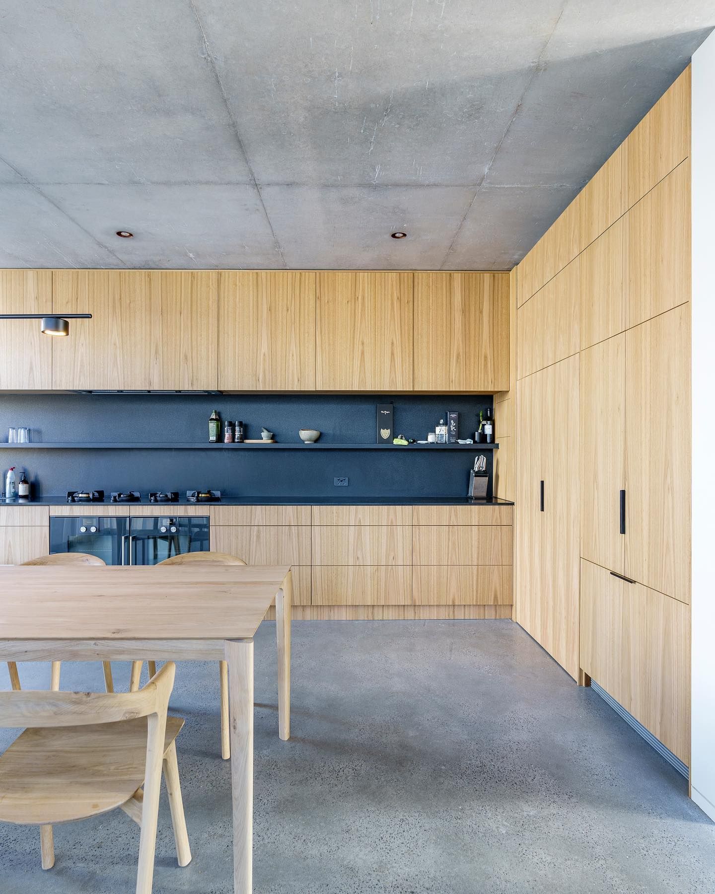 A kitchen with wooden cabinets and a table and chairs