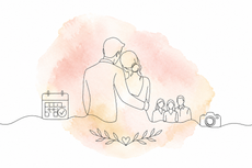 Couple embracing outdoors with soft pink watercolor background, small house and people in distance