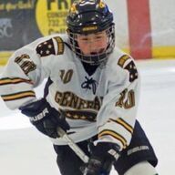 Hockey player in white jersey with black and gold accents, holding a hockey stick, on the ice.