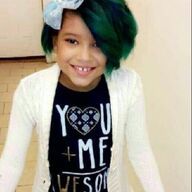 Girl with green hair, wearing a white sweater and a 