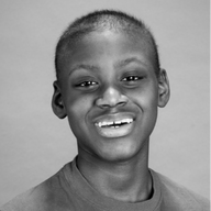 Smiling person with short hair, looking at the viewer.
