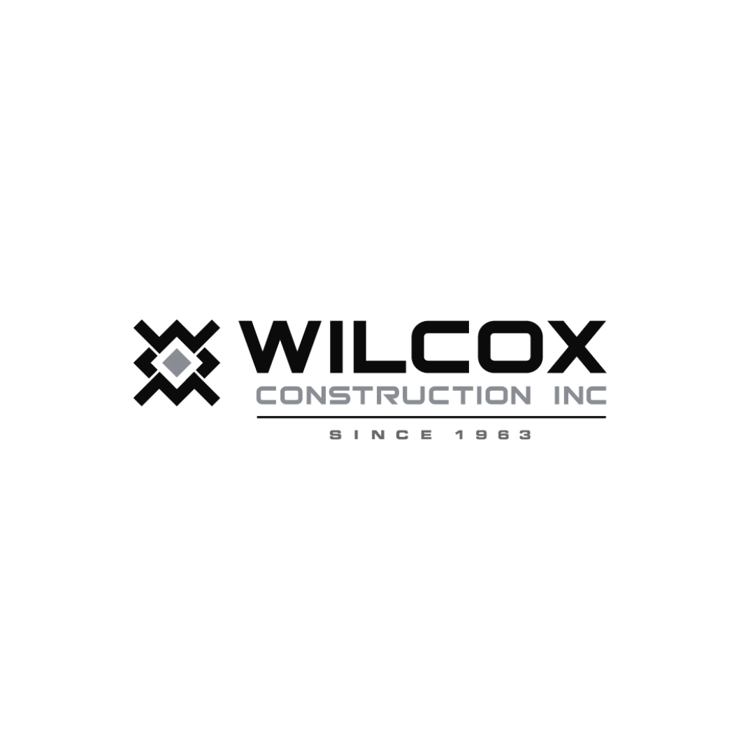 A black and white logo for wilcox construction inc.