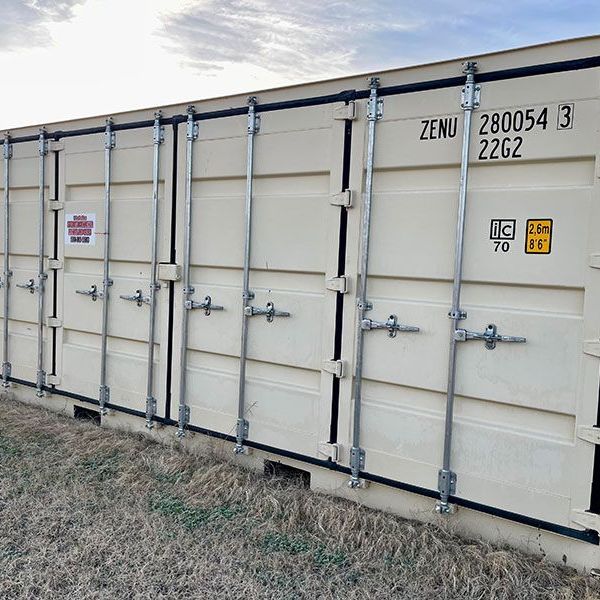 A row of white shipping containers with the numbers 28054 3 and 2262 on them