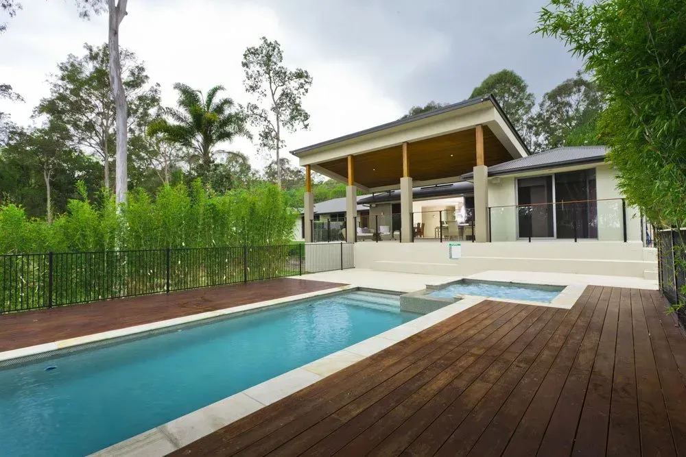 A House With A Large Swimming Pool In Front Of It — Anytime Conveyancing In Wingham, NSW