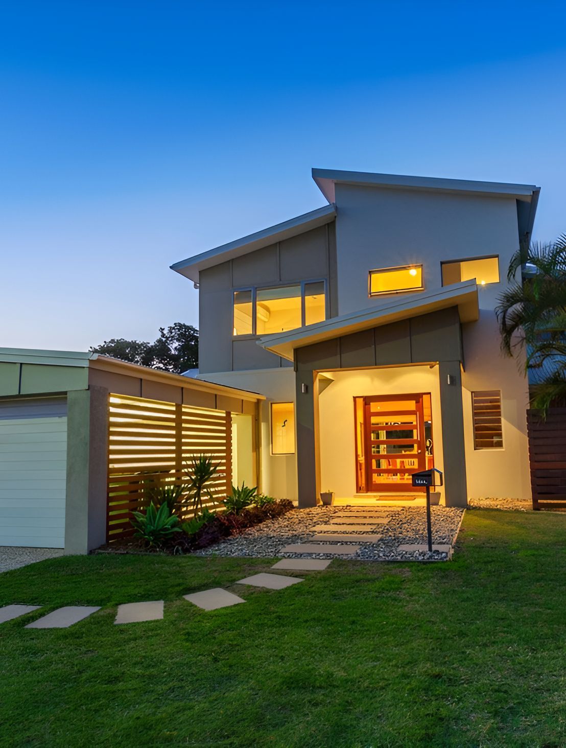 A Large House With A Lush Green Lawn In Front Of It — Anytime Conveyancing In Smiths Lake, NSW