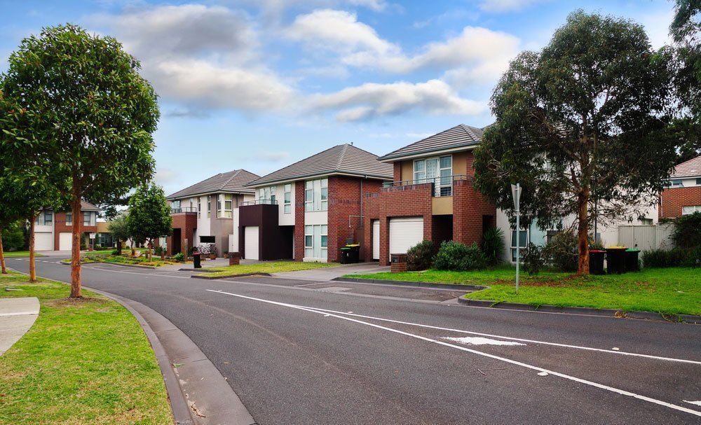 A Row Of Houses On The Side Of A Road — Anytime Conveyancing In Forster, NSW