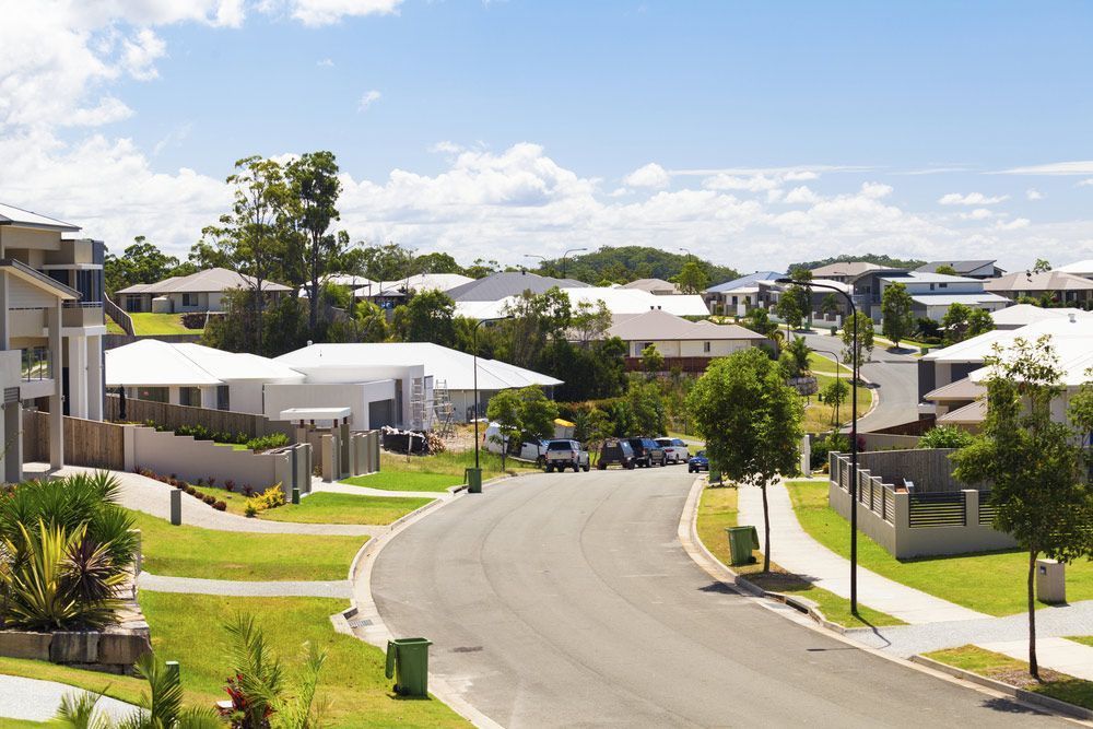 A Residential Area With Lots Of Houses And Trees On A Sunny Day — Anytime Conveyancing In Nabiac, NSW