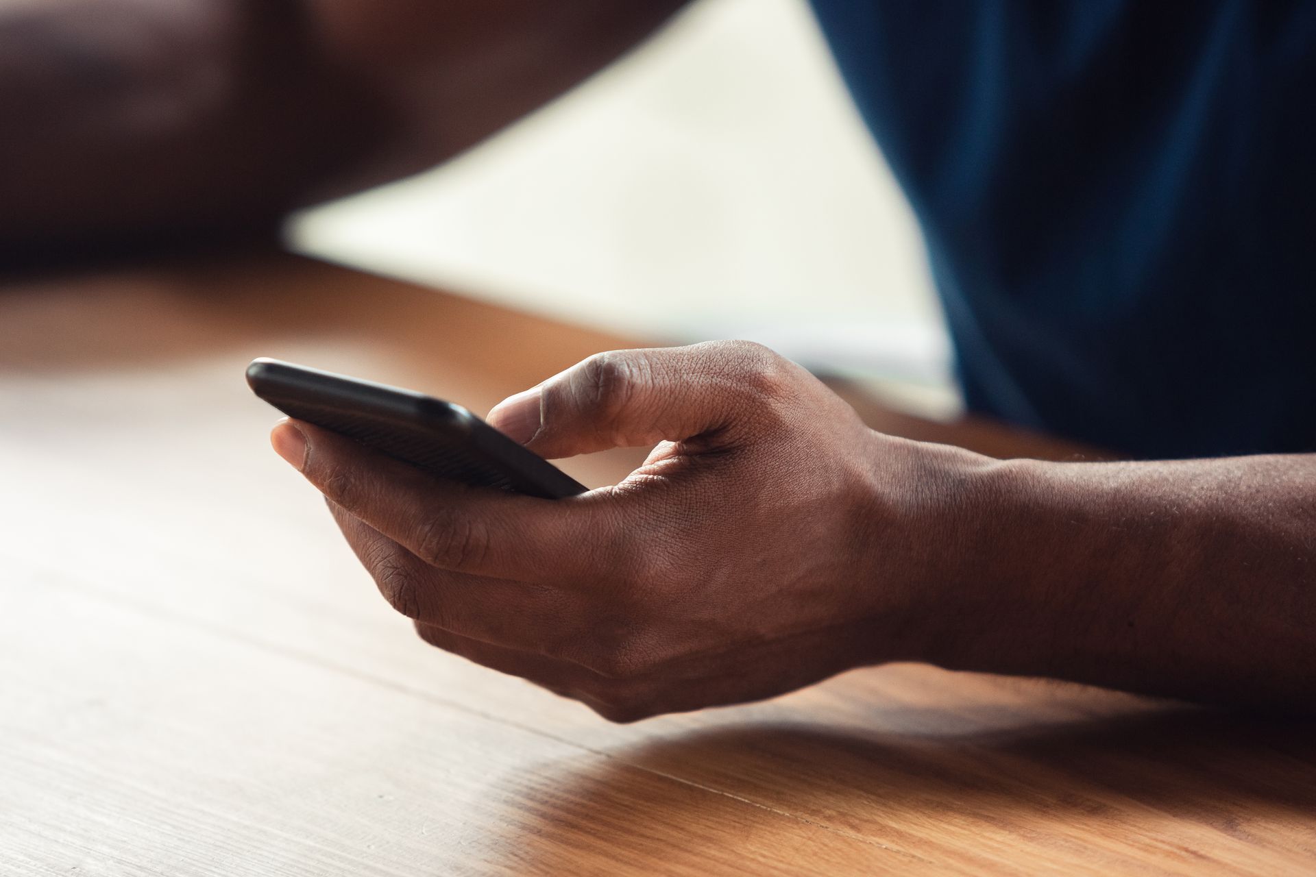 A person is holding a cell phone with five stars on it.