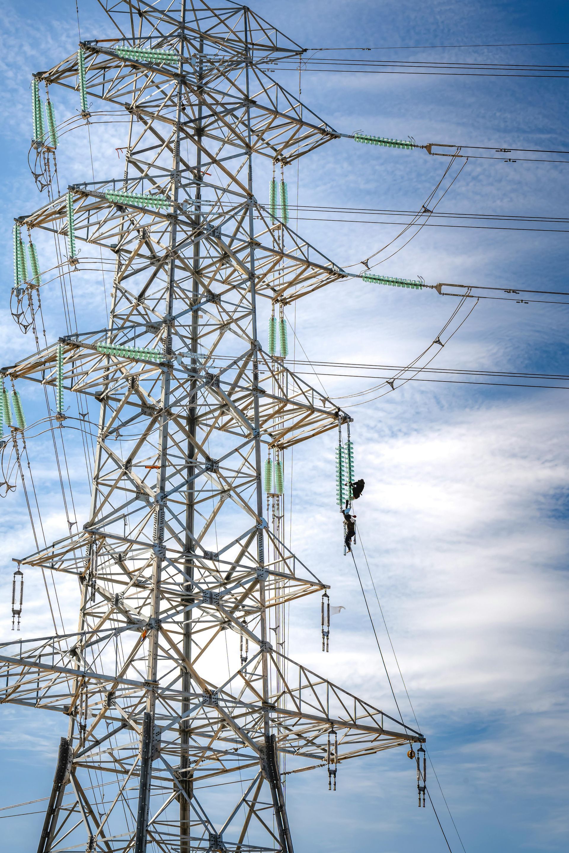 A tower with birds flying around it and a blue sky in the background