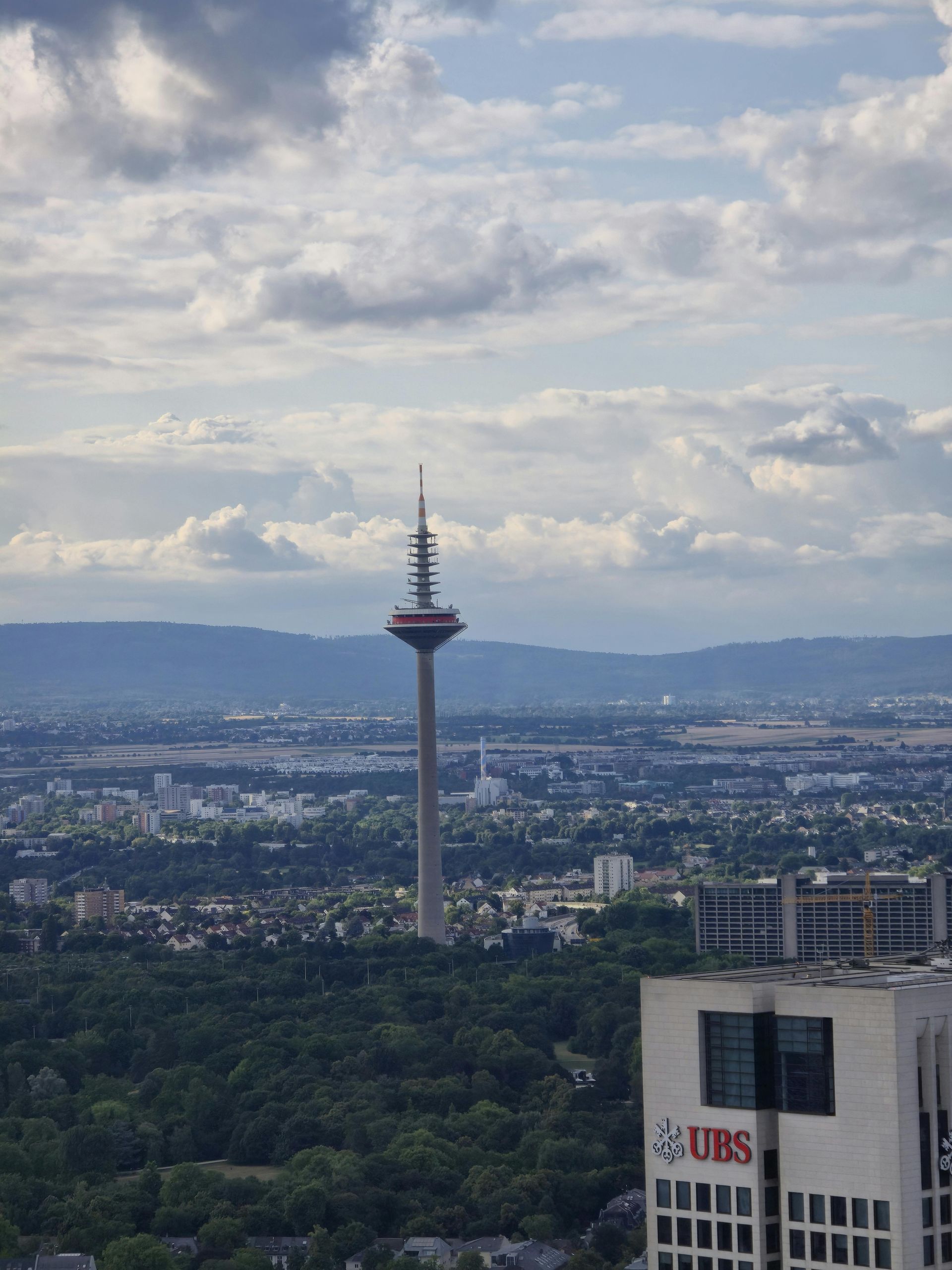 An aerial view of a city with a ubs building in the foreground