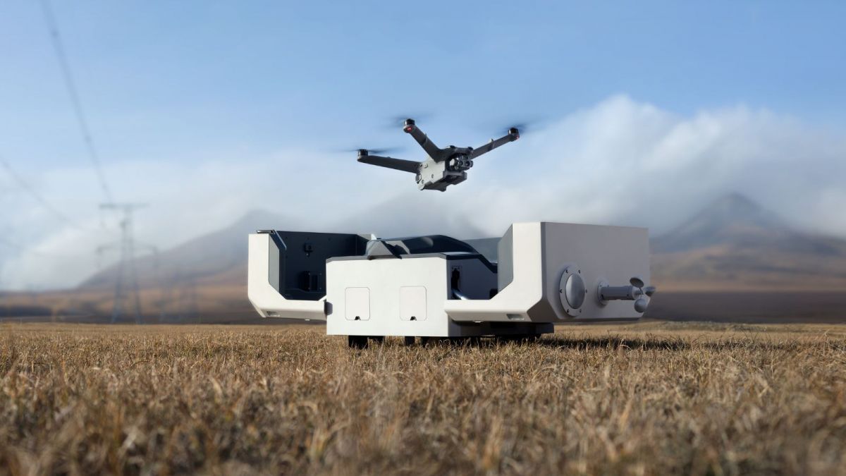 A drone is sitting on the ground in a concrete room.