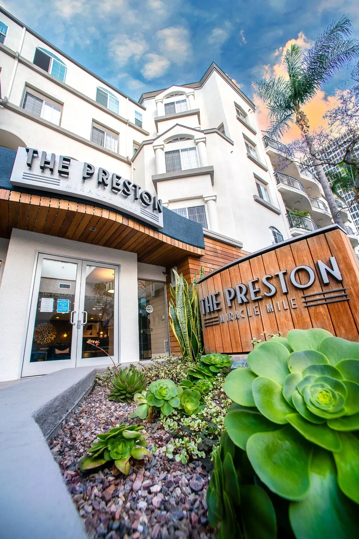 The Preston Miracle Mile apartment building entrance and signage.