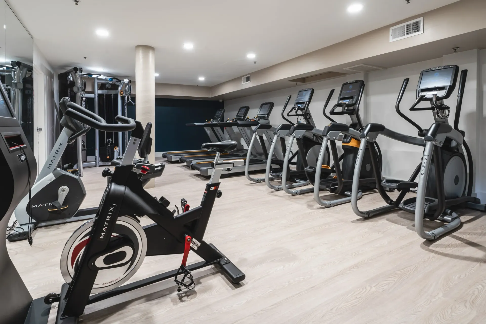 Gym with treadmills, ellipticals, and stationary bikes.