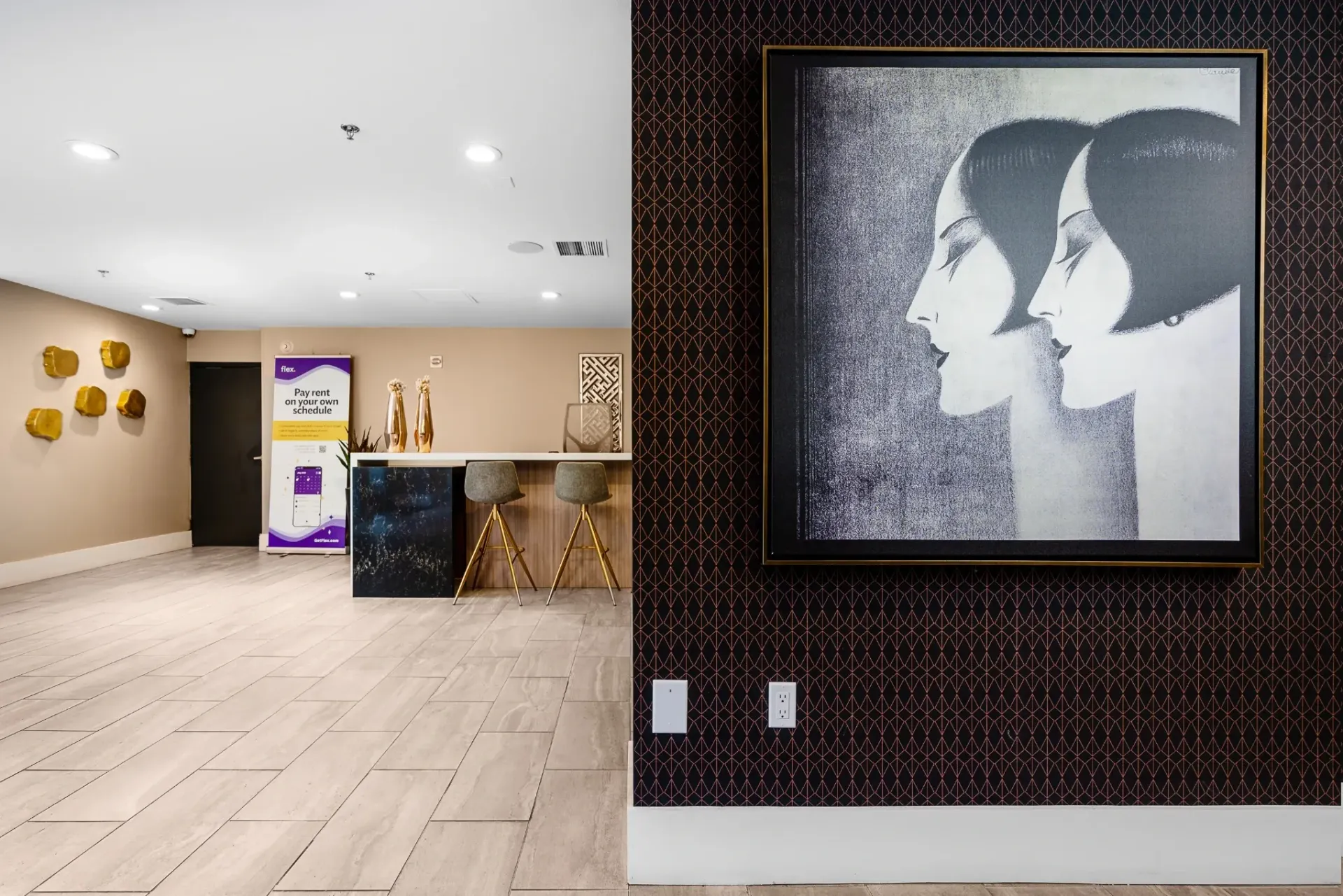 Modern lobby with abstract art and a reception desk.