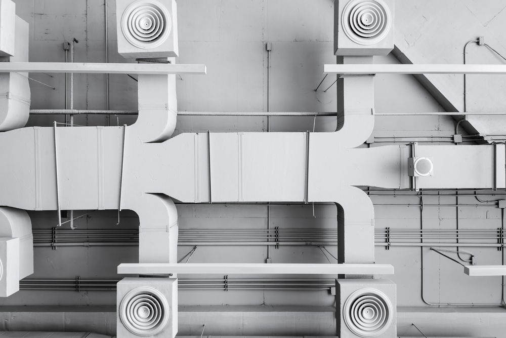 A Bunch of White Pipes and Fans Are Hanging From the Ceiling of a Building — HTH Sheetmetal Mackay in Mackay, QLD