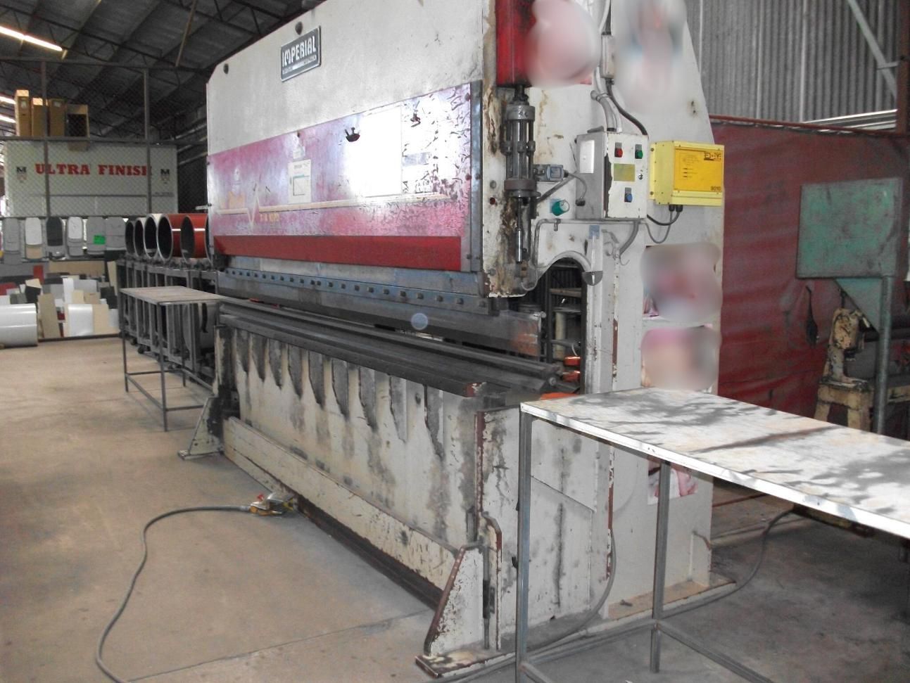 A Large Machine is Sitting in a Warehouse Next to a Table — HTH Sheetmetal Mackay in Mackay, QLD