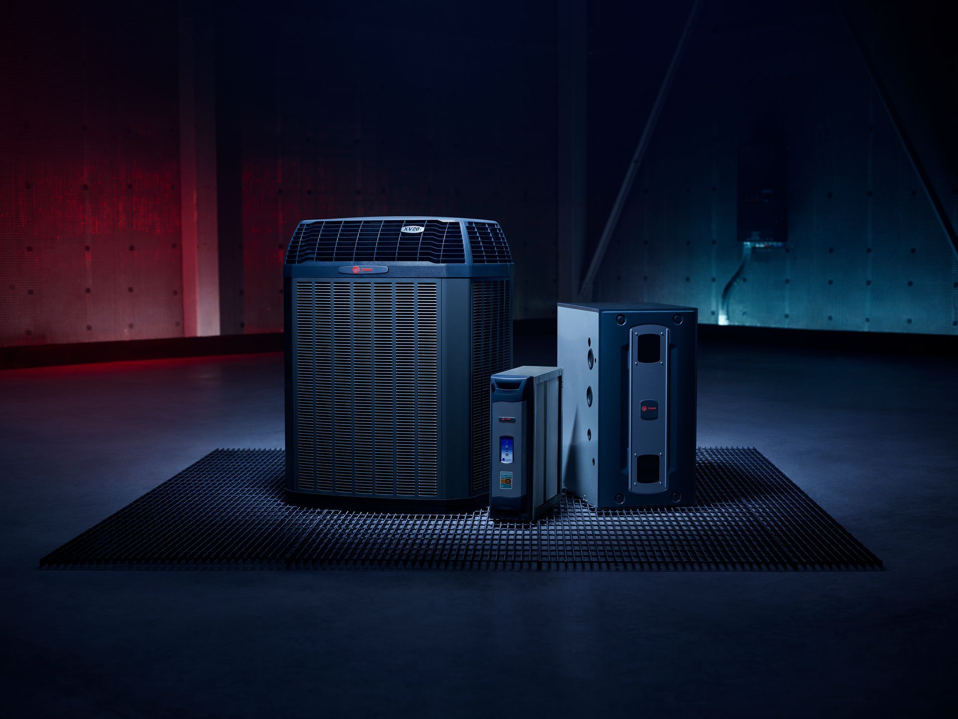 Black computer tower with two drives on a dark studio floor, lit by red and blue accent lights