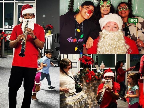 A man in a santa hat is playing a clarinet.