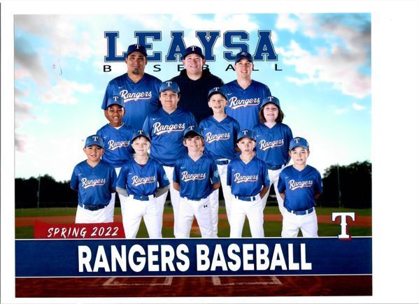 The rangers baseball team is posing for a picture on the field.