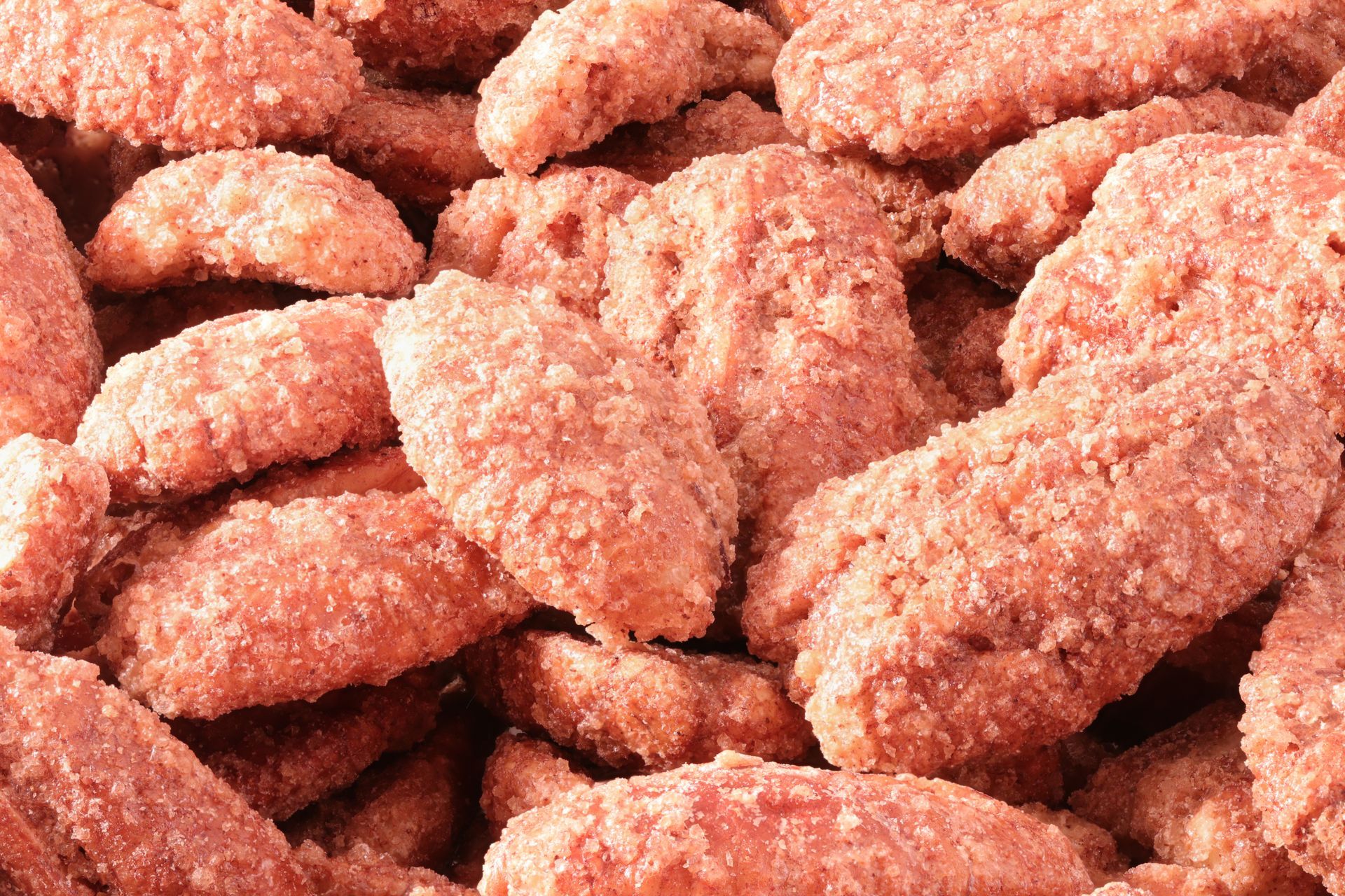 Close-up of crispy breaded chicken strips piled together, golden brown and textured