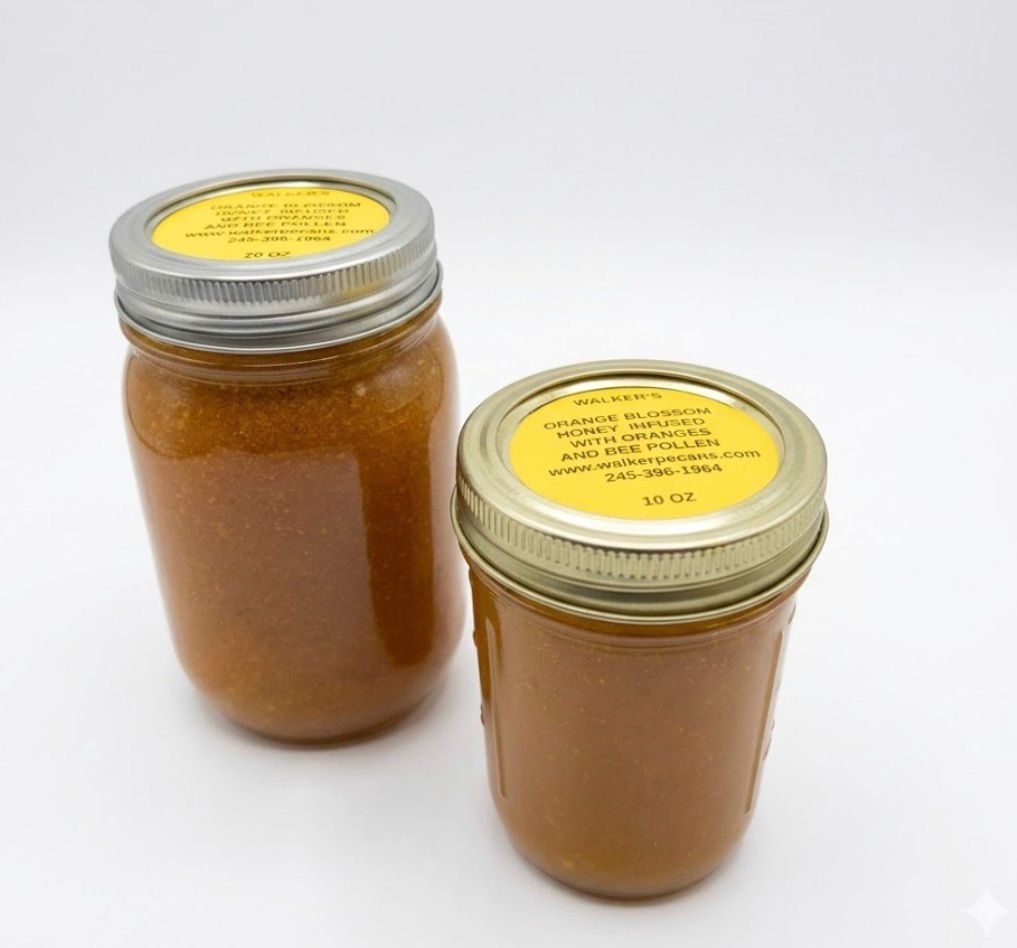 Orange smoothie being poured into a jar, with whole and sliced oranges on a white background
