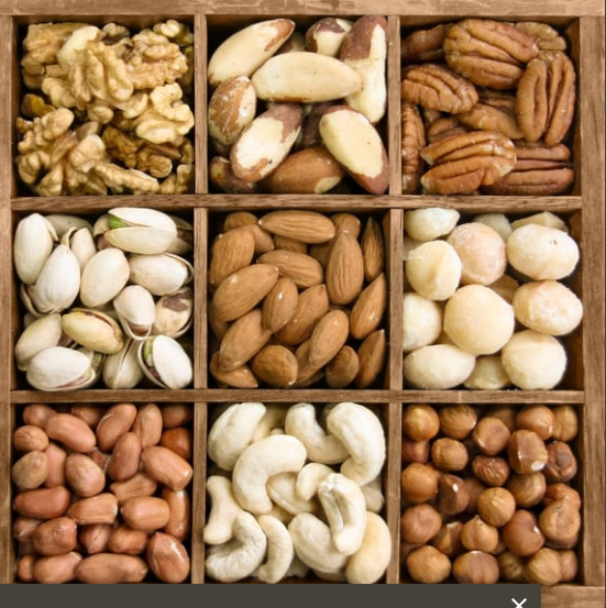 Assorted nuts in a wooden tray, separated into nine compartments.