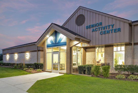 Senior Activity Center building exterior with lighted entrance at dusk.
